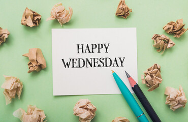 Piece of paper with the words Happy Wednesday written on it
