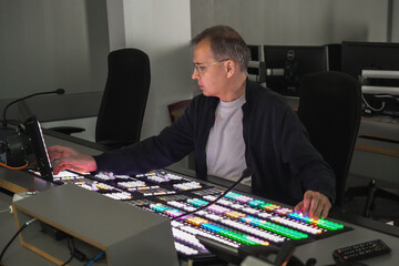 BIMI Operating Professional Video Switcher Console in Broadcast Control Room