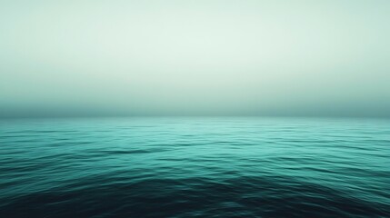 Obraz premium Tranquil turquoise ocean with gentle waves and a misty horizon for peaceful backgrounds