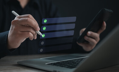 User completing checklist tasks using stylus and mobile device over a digital interface,...