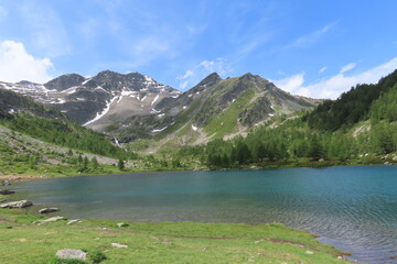 L'incantevole lago di Arpy in Valle d'Aosta, circondato dal verde e dalle montagne.