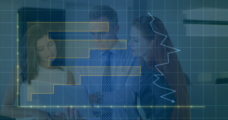 Reviewing three coworkers examining numerical data on open laptop in office, with chart overlays