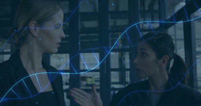 Speaking two businesswomen discussing biotech data in office space, with DNA helix overlay
