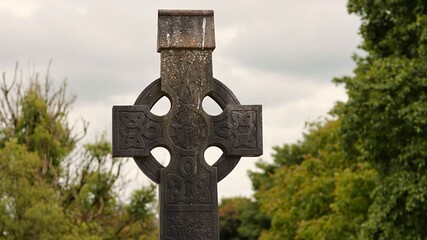 Old stone celtick cross in cemetery