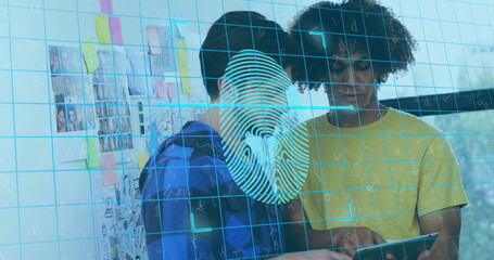 Collaborating duo examining tablet in office, with sticky notes wall and fingerprint graphic