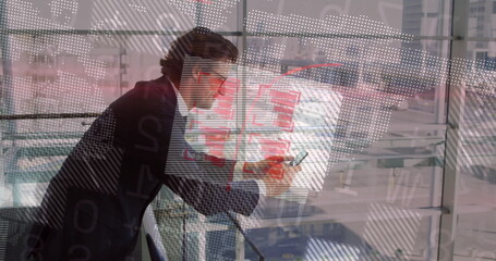 Leaning man in suit using phone near metal railing at airport terminal, with data projections