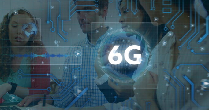 Discussing group of colleagues reviewing 6G technology sketches in office, with laptop and notepad