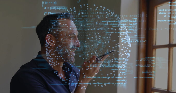 Speaking into smartphone, man issuing voice commands in room near window, with holographic code - Powered by Adobe