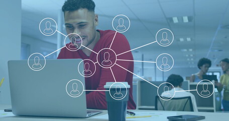 Man working on laptop with network connections image overlay in office