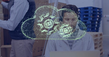 Cloud computing image over person working on laptop in office setting