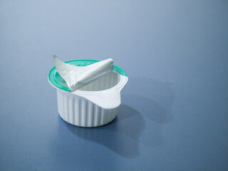 A white plastic container with a lid on top