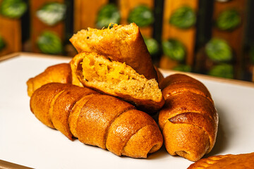 horizontal photo of open empanada with pineapple inside and artisanal whole cheese sticks, sweetened with honey, in a healthy vegetarian restaurant in Colombia