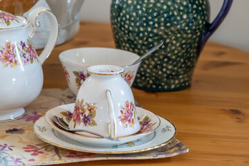 Close and selective focus on a bone China tea cup and saucer on a wooden table