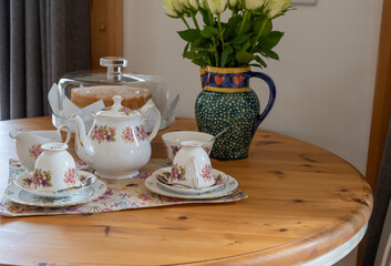 Close and selective focus on a bone China tea cup and saucer on a wooden table