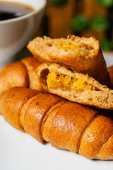 Vertical photo of open empanada with pineapple inside and artisanal whole cheese sticks, sweetened with honey, in a healthy vegetarian restaurant in Colombia
