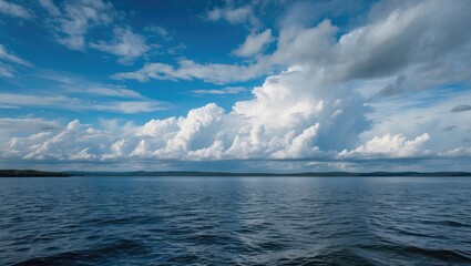Fototapeta premium A vast body of water with a sky filled with clouds, peaceful and expansive.