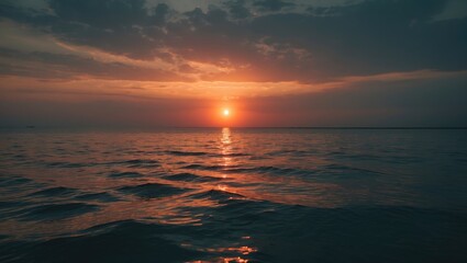 Obraz premium Sunset over the ocean with the sun near the horizon and reflecting on the water. Nature and landscape, sky and sea, beautiful view.