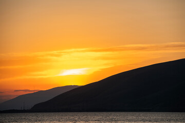 Beautiful sunset with clouds over the lake.