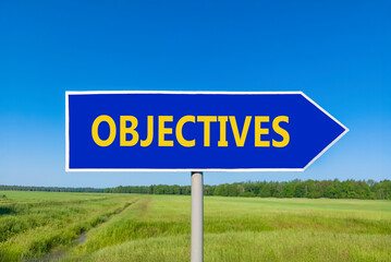 Objectives symbol. Concept word Objectives on beautiful blue road sign. Beautiful blue sky green grass and forest peaceful nature background. Business objectives concept. Copy space.