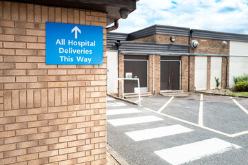 Hospital delivery sign showing NHS delivery drivers which way to delivery hospital and clinical items seen at a typical NHS hospital in Britain.