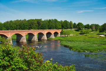 Fototapeta premium Historic Brick Bridge Over the Venta River in Kuldīga, Latvia