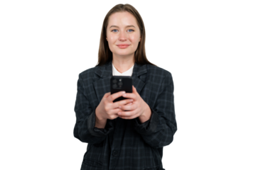 Young woman in business attire holds smartphone while smiling confidently in a studio setting 
