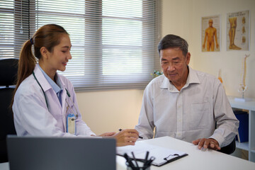 Female doctor having a discussion with an elderly patient during a medical consultation. Health...
