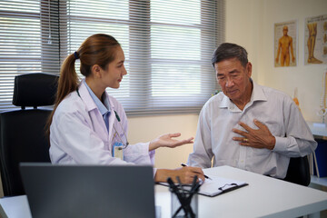 Female physician assessing a senior patient reporting chest pain in a clinical. Health care concept.