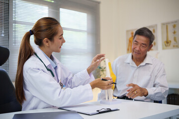 Elderly man consulting with a physician about joint pain and mobility issues in a clinical.