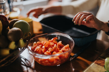 Hands working in a kitchen with fresh ingredients on a wooden table, evoking a sense of home cooking, preparation, and culinary creativity. The scene emphasizes vibrant colors, food, and activity.