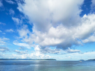 Obraz premium Expansive Tropical Ocean View with Dramatic Clouds and Distant Islands in Indonesia
