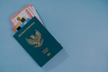 Passport, money and credit card isolated on light blue background with copy space for text.