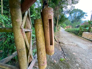 bamboo gongs at a security post in a village