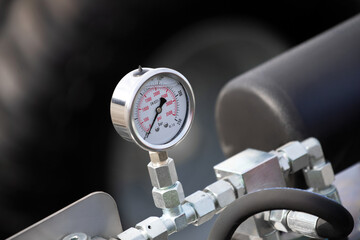 A pressure gauge is attached to a pipe