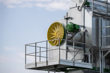 A large fan is mounted on a metal structure
