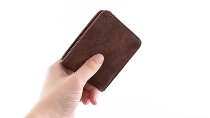 Hand holding a brown leather wallet against a white background in a neutral setting