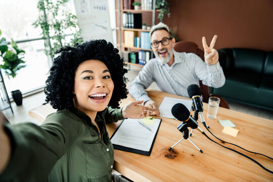 Friendly coworkers recording a podcast in a stylish office showcasing collaboration and teamwork - Powered by Adobe