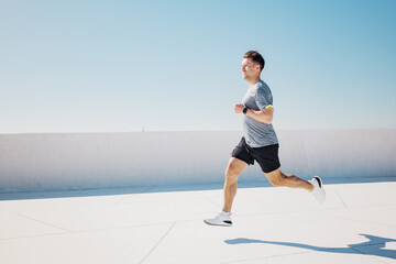 Running towards wellness on a sunlit rooftop in a vibrant urban landscape during a clear blue day