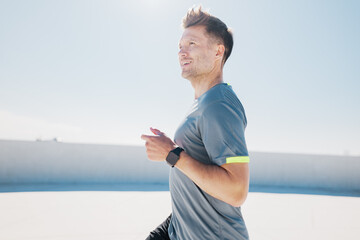 Runner enjoys morning jog under bright blue sky, soaking in sun and fresh air while tracking...