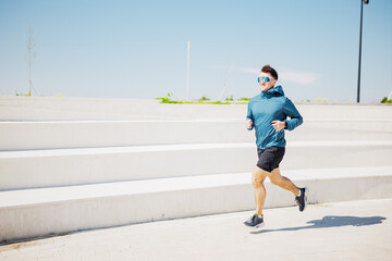 Energetic morning jogger in vibrant park under clear blue sky enjoying an invigorating workout