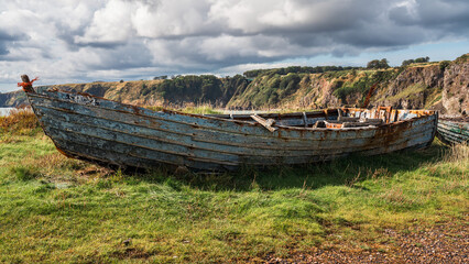 Remains of boats on the North Sea coast of Boddin, Scotland, UK