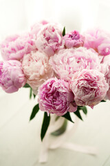 Beautiful Pink Peony Bouquet with Soft Petals and Green Leaves in a Vase