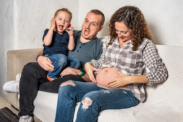 Happy family with pregnant woman expecting another baby.
Concept of maternity, parenting, preparation and expectation for baby.