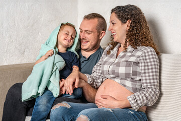 Happy family with pregnant woman expecting another baby.
Concept of maternity, parenting, preparation and expectation for baby.