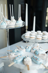Elegant Blue and White Dessert Table with Cake Pops, Macarons, and Candied Treats for a Special Event