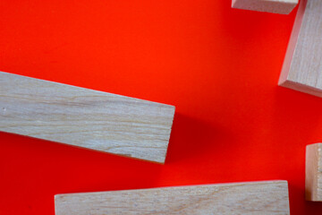 This vibrant abstract composition features wooden blocks on a rich orange background, creating a...