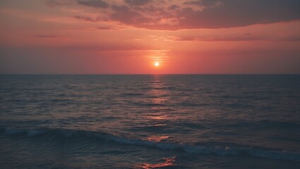 Sunset over the ocean with calm waves and colorful sky. Natural scenery. Tranquil and scenic view of water and sunset.