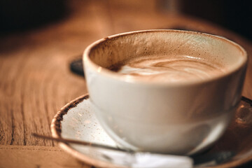 close up cup of coffee cup on the right that has had a sip taken from it