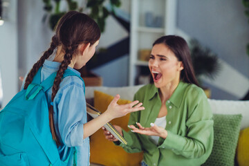 Mother and daughter bonding at home discussing a school project, fostering communication and...