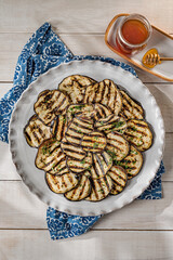 Roasted eggplant fritters with honey dressing.
Grilled and sliced eggplant appetizer.